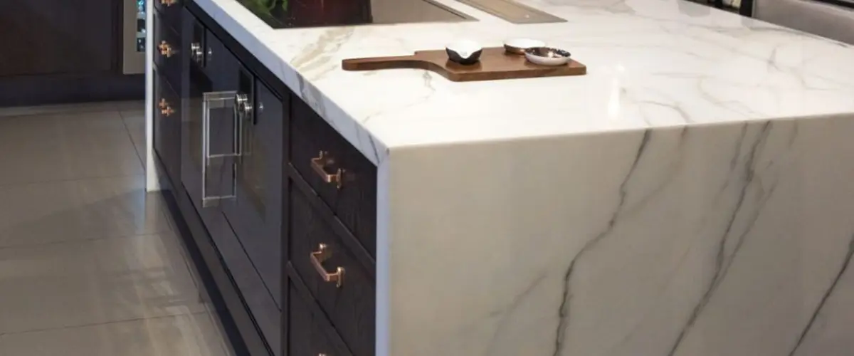 marble kitchen island with dark cabinet