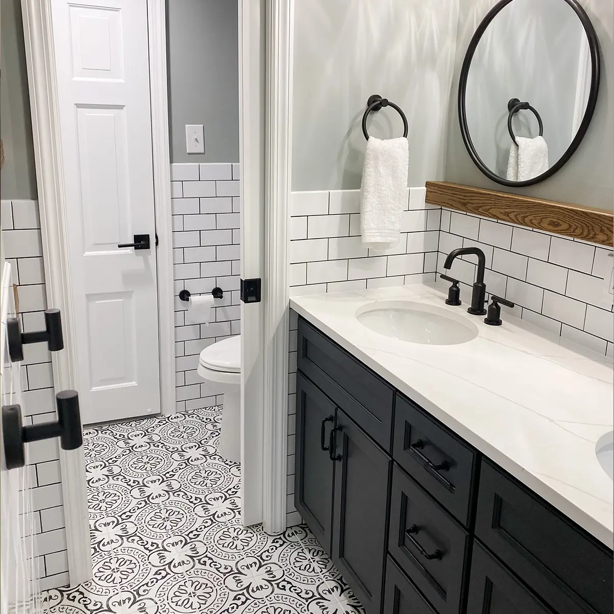 A small bathroom with beautiful tile flooring and tile backsplash