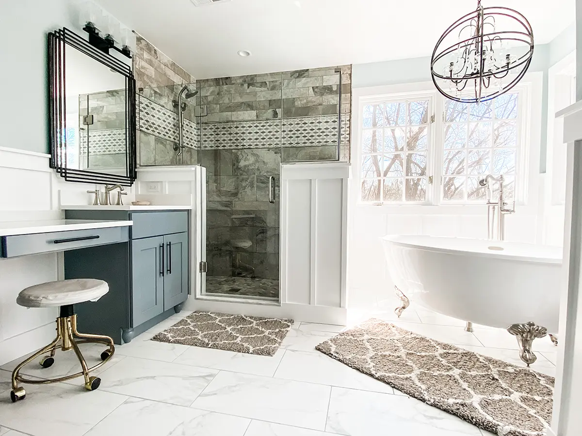 A beautiful bathroom with large tile flooring, freestanding tub, and glass walk-in shower
