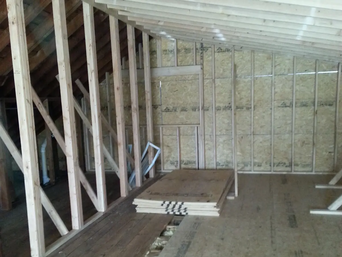 An attic remodel with the wood frame and drywall visible