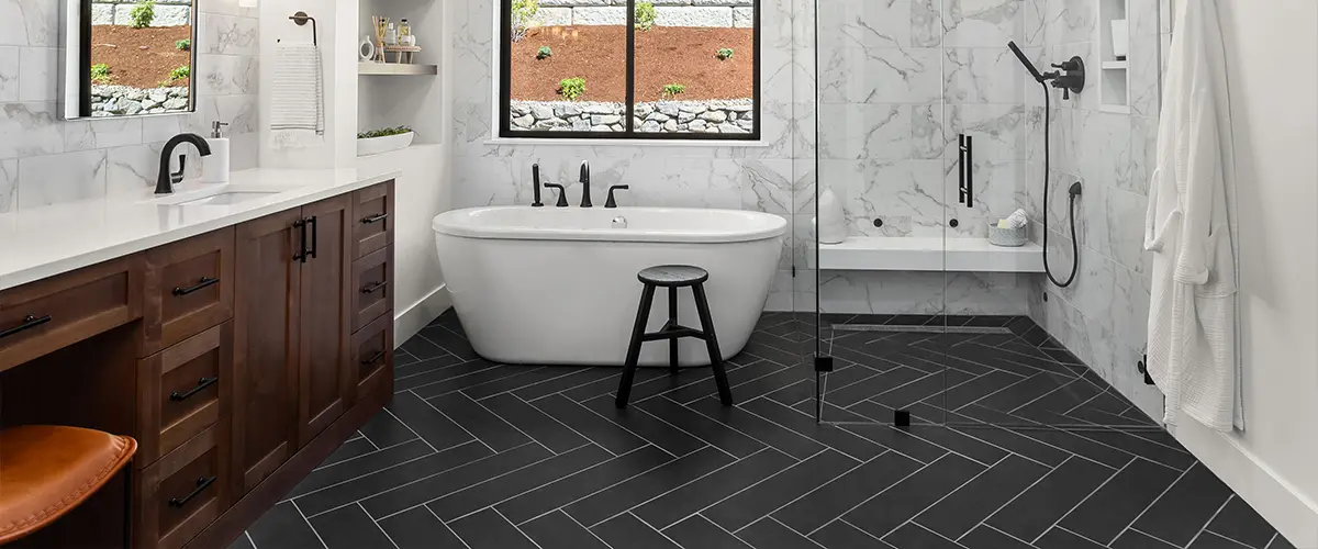 How to renovate a bathroom with the best bathroom flooring ideas with dark tile flooring and freestanding tub