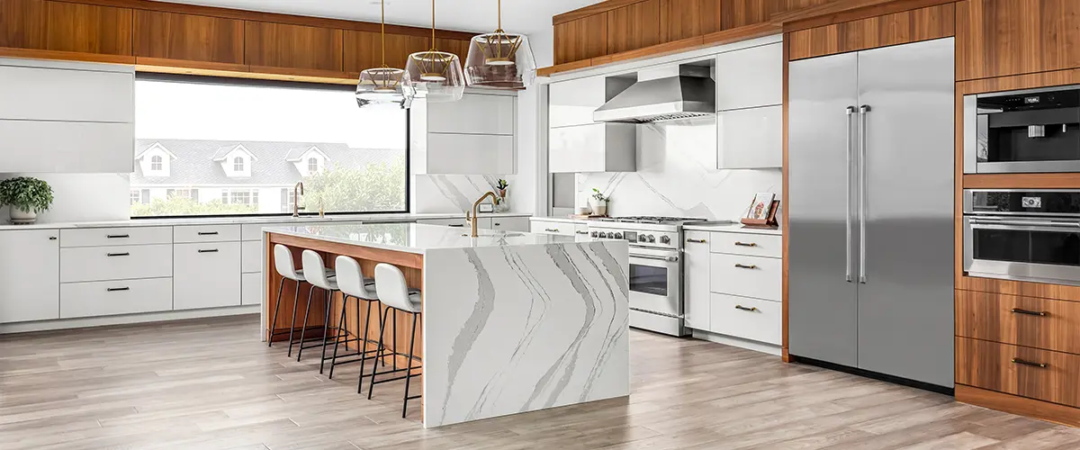 Expensive-looking kitchen remodel with a waterfall marble countertop and wood cabinets