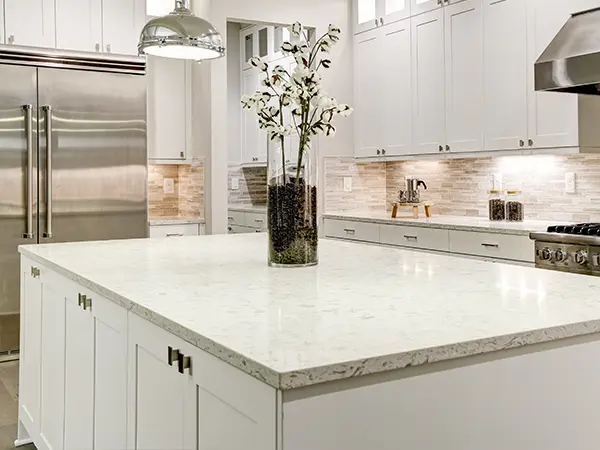 White countertops with a black vase and flowers
