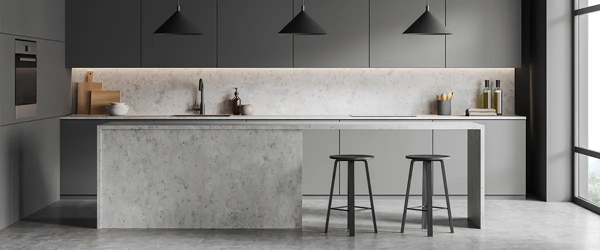 A gray kitchen space with concrete kitchen counters