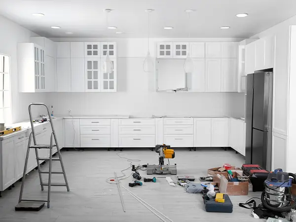 A kitchen remodel with white cabinets and LVP floor