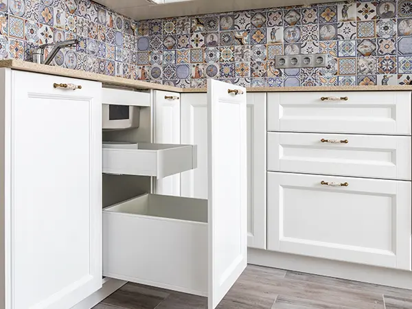 White kitchen cabinets and drawers with silver handles
