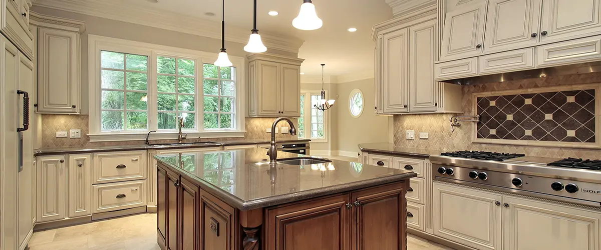 Traditional cabinets in white with a kitchen island and granite