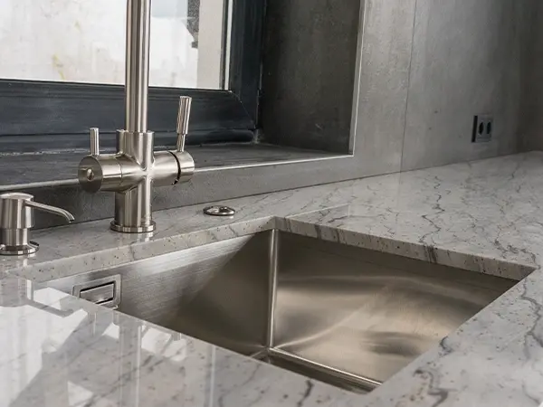 A granite counter and an undermount sink