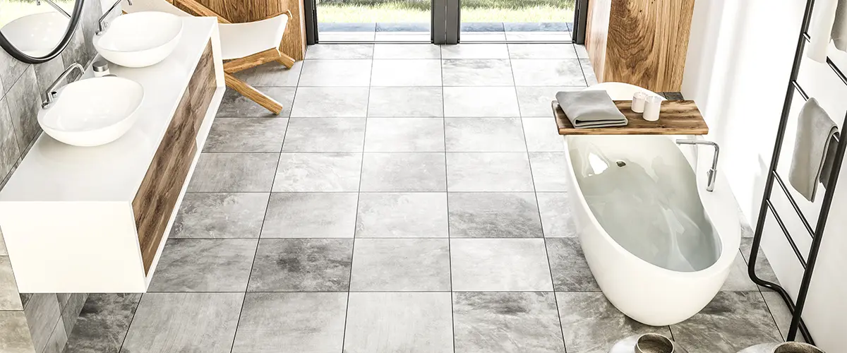 Bathroom flooring with large gray tile and wood features