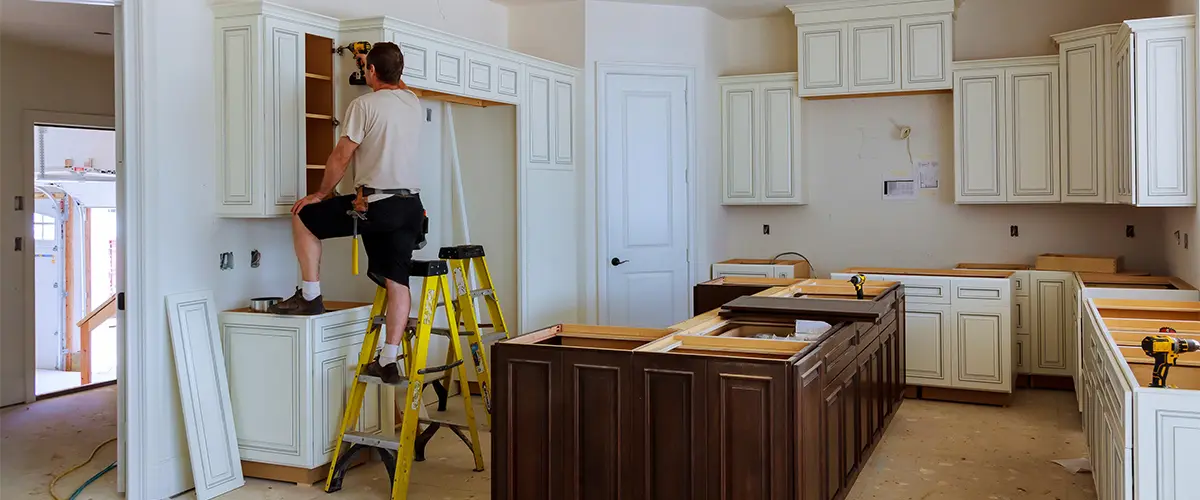 Contractor installing kitchen cabinets in kitchen remodeling mistakes