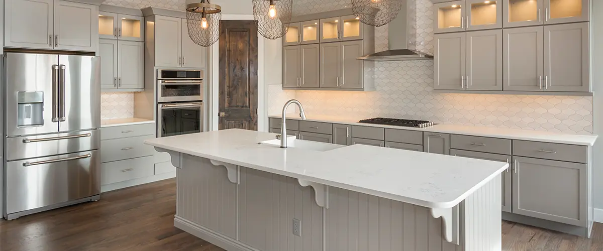 A kitchen remodel with white cabinets