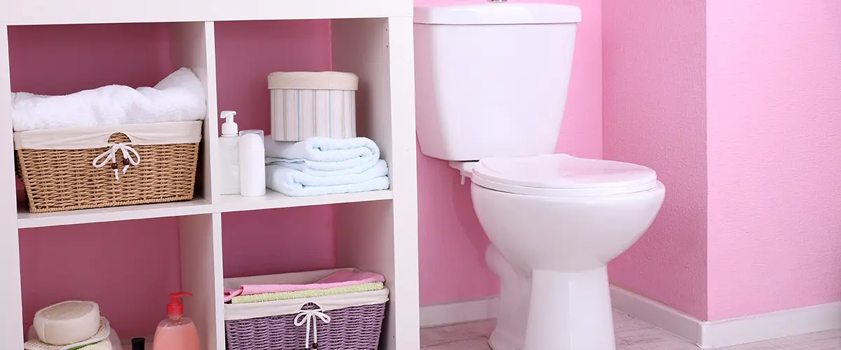 Open shelves in a bathroom painted pink