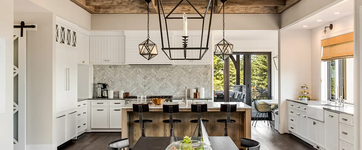 A kitchen remodel with wood accents and big lighting fixtures