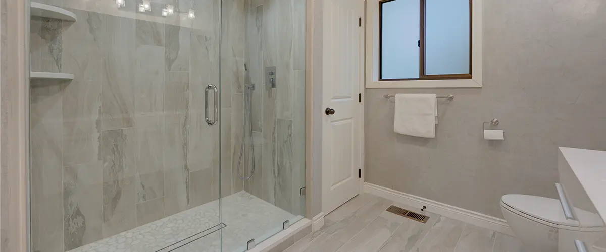 Large glass shower in white bathroom