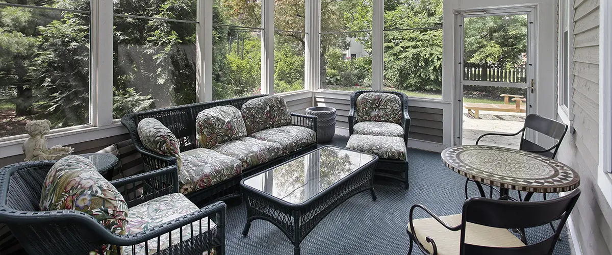 A sunroom addition with outdoor furniture