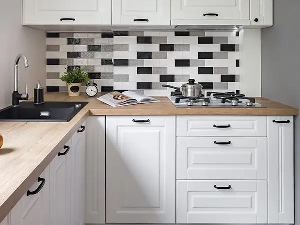 White cabinets with dark pulls in a small kitchen