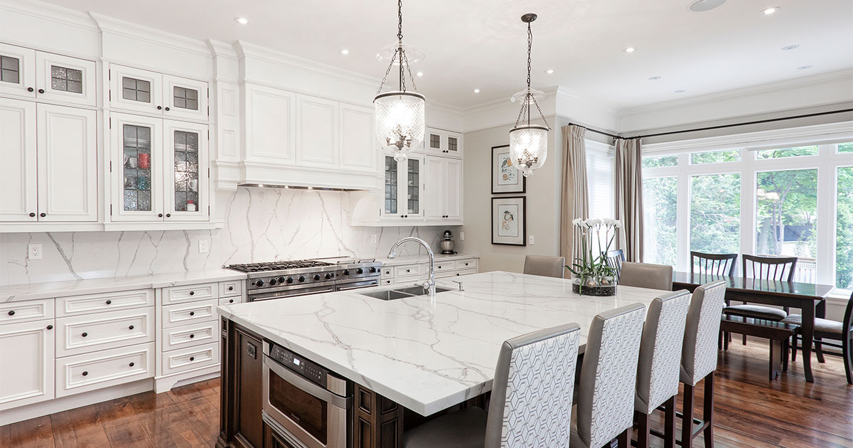 White kitchen cabinets with large kitchen island made of quartz in a kitchen remodel in Ardmore, PA