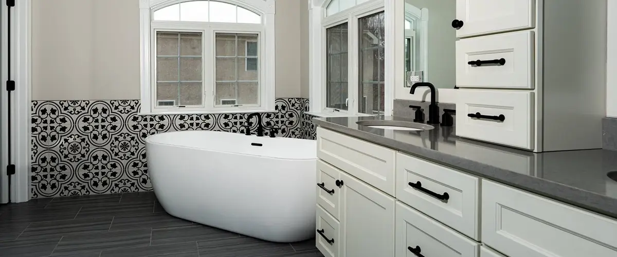 A freestanding tub in a large bathroom with a large vanity