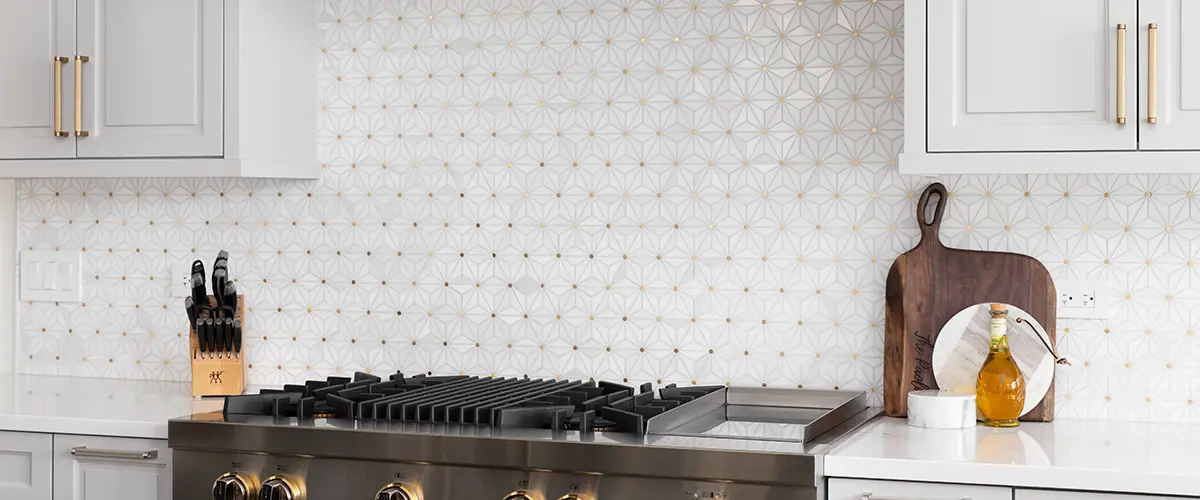 Beautiful design on a tile backsplash with white kitchen cabinets