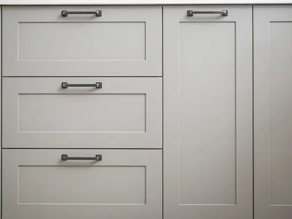 Off-shite kitchen cabinets with silver pulls