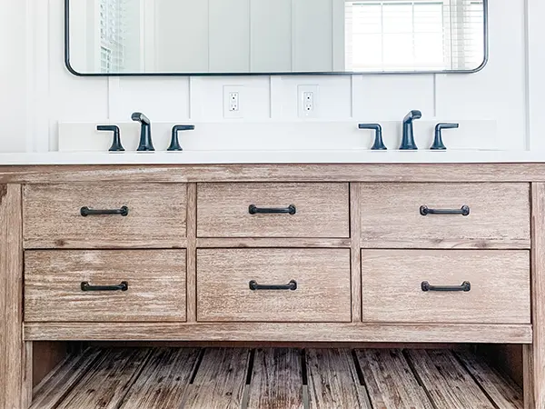 A double wood vanity with black hardware