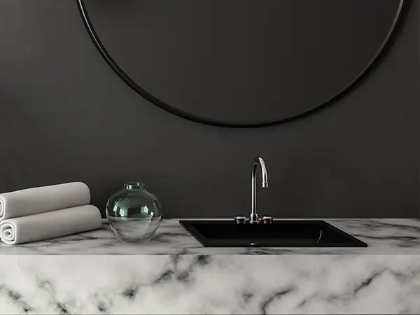 A marble countertop with black walls and black window frame