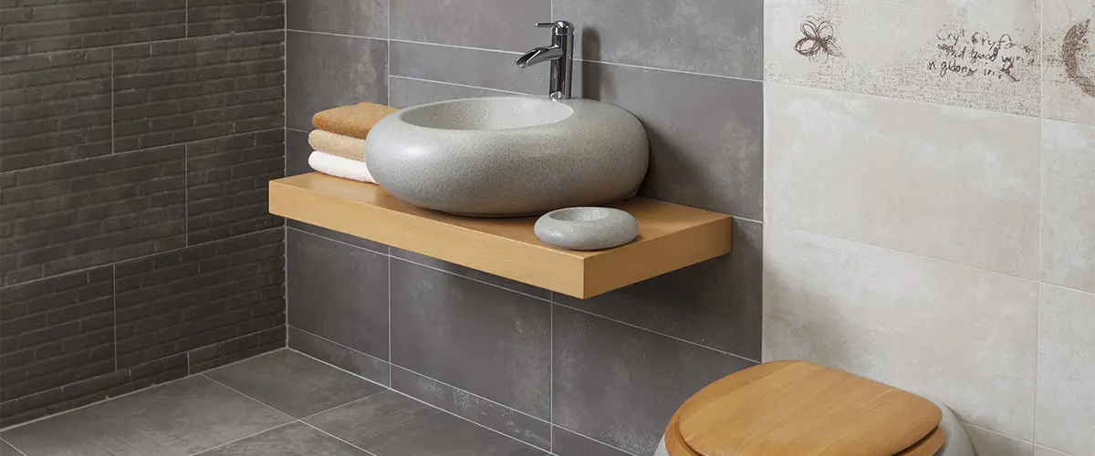 A ceramic sink and toilet with wood features