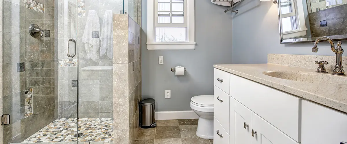 A walk-in shower with tile surround