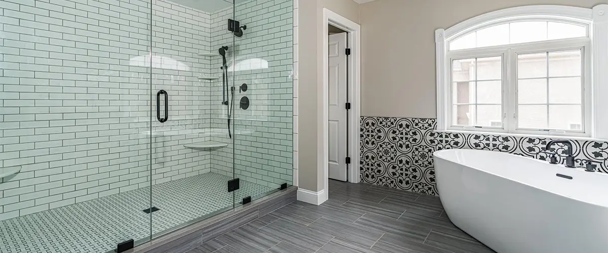 Freestanding tub with a glass shower enclosure