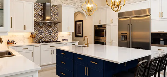 Kitchen remodel with navy blue island and white cabinets