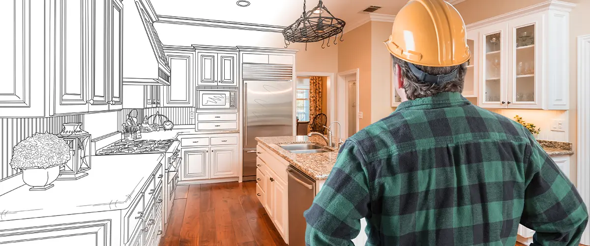 Male Contractor with Hard Hat and Tool Belt Looking At Custom Kitchen Drawing Phot