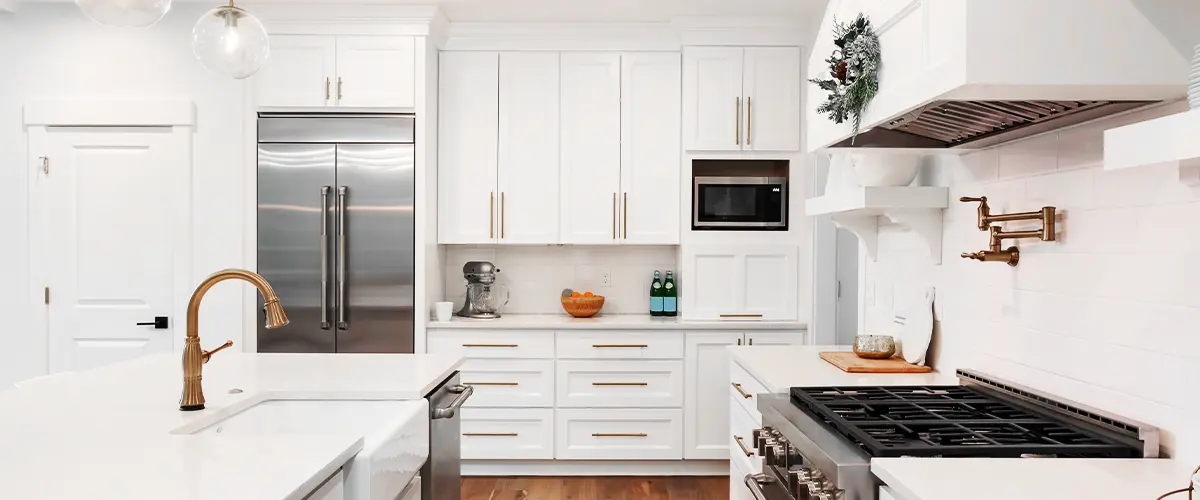 Beautiful kitchen detail in new luxury home. Features island, pendant lights, hardwood floors
