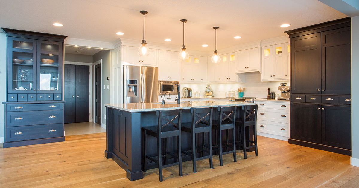 Custom kitchen with built in appliances, hard wood floors, and light and dark cabinetry