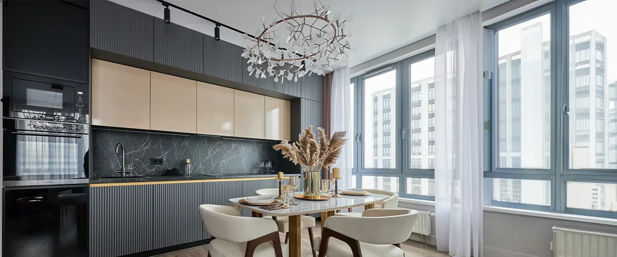 Modern interior of studio apartment in gray and white colors and tones with chandelier over dining table.