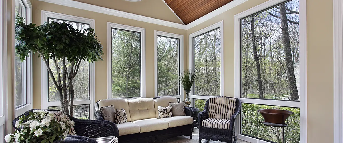 Stylish home additions in Rosemont sunroom with panoramic greenery view.