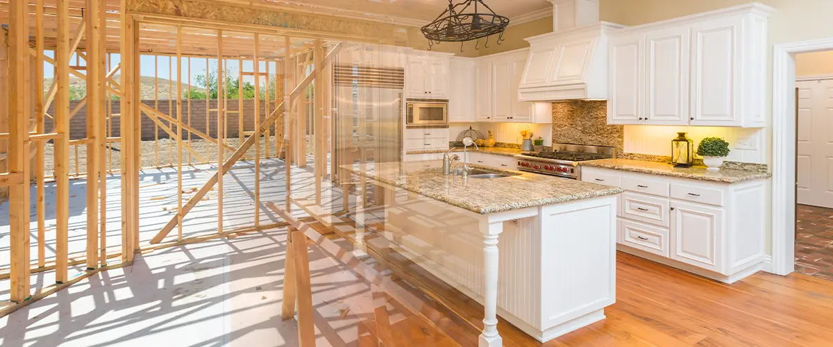 Home remodeling in devon showing unfinished construction to a completed modern kitchen with white cabinets, granite countertops, and stainless steel appliances.