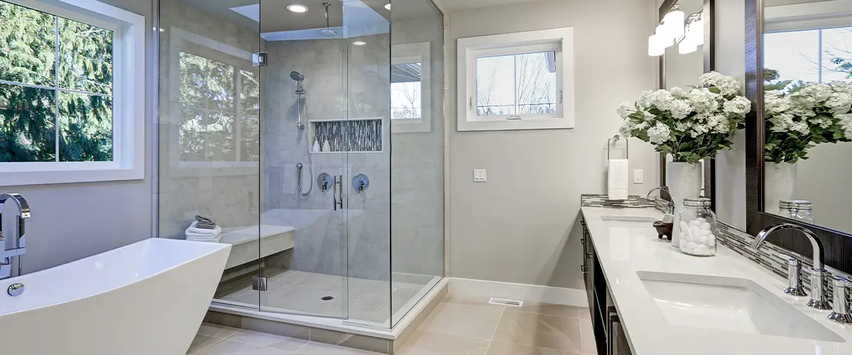 Modern bathroom remodel in devon featuring a freestanding tub, glass shower enclosure, and double vanity with elegant fixtures, perfect for luxurious home upgrades