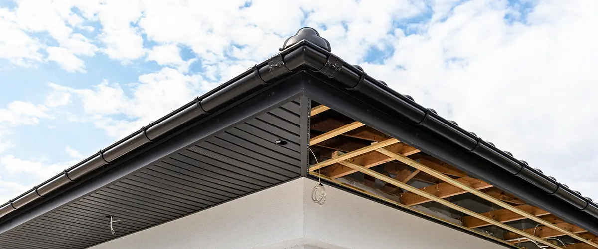 Scaffolding with three rows of wooden battens and a modern graphite Fascia And Soffit Installation In Springfield