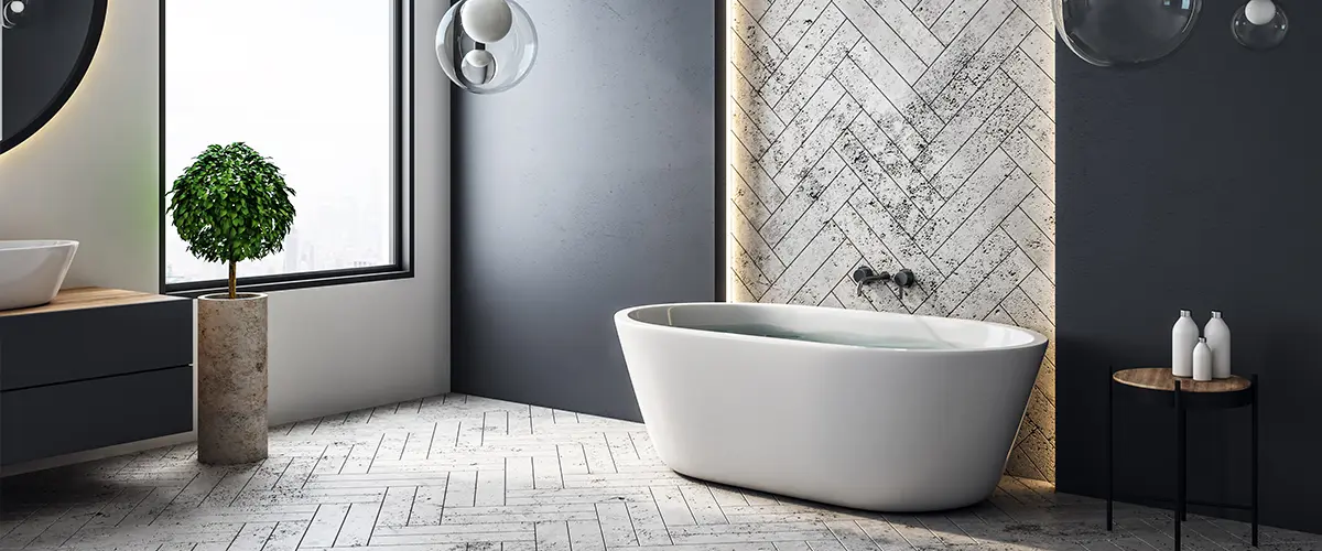 Modern bathroom remodeling in Springfield, with a freestanding bathtub, herringbone tile accent wall, minimalist decor, and large window with city view.