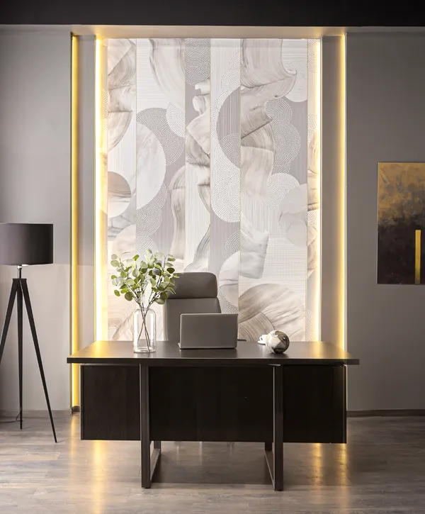 Contemporary office design with a minimalist black desk, decorative wall paneling, and a tripod floor lamp next to large windows