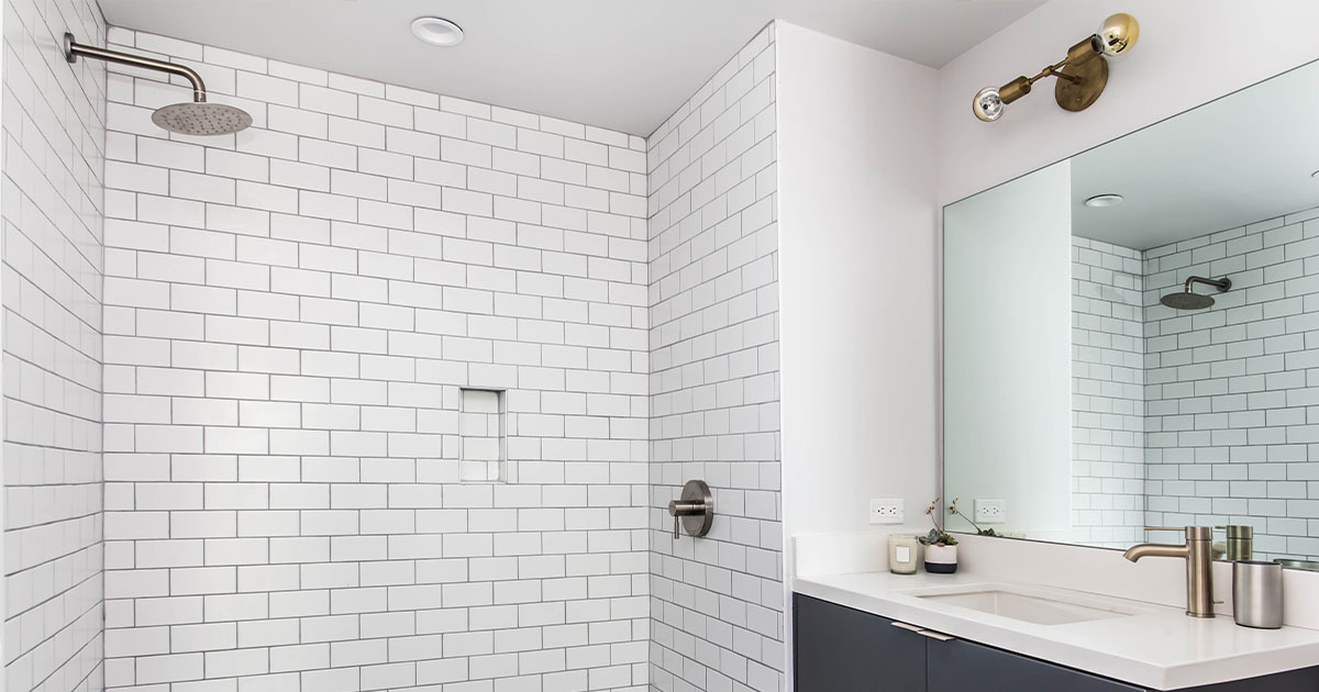 Modern bathroom with white subway tiles and hexagonal floor tiles