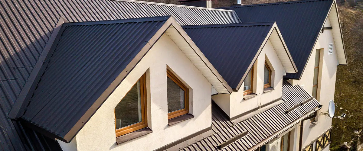 Residential home with dark steel roofing, showcasing modern architectural design and energy-efficient roofing material.