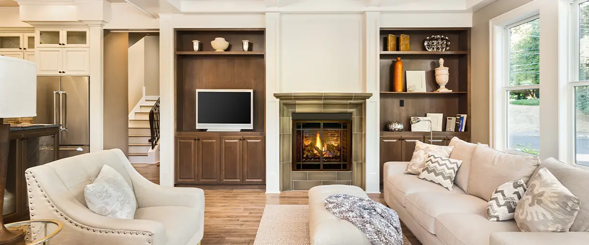 Elegant living room with coffered ceiling, built-in shelves, and cozy fireplace in luxury home interior design.