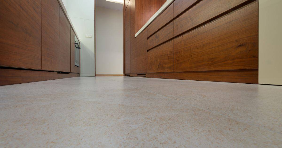 Close-up of a modern kitchen floor with wooden cabinetry