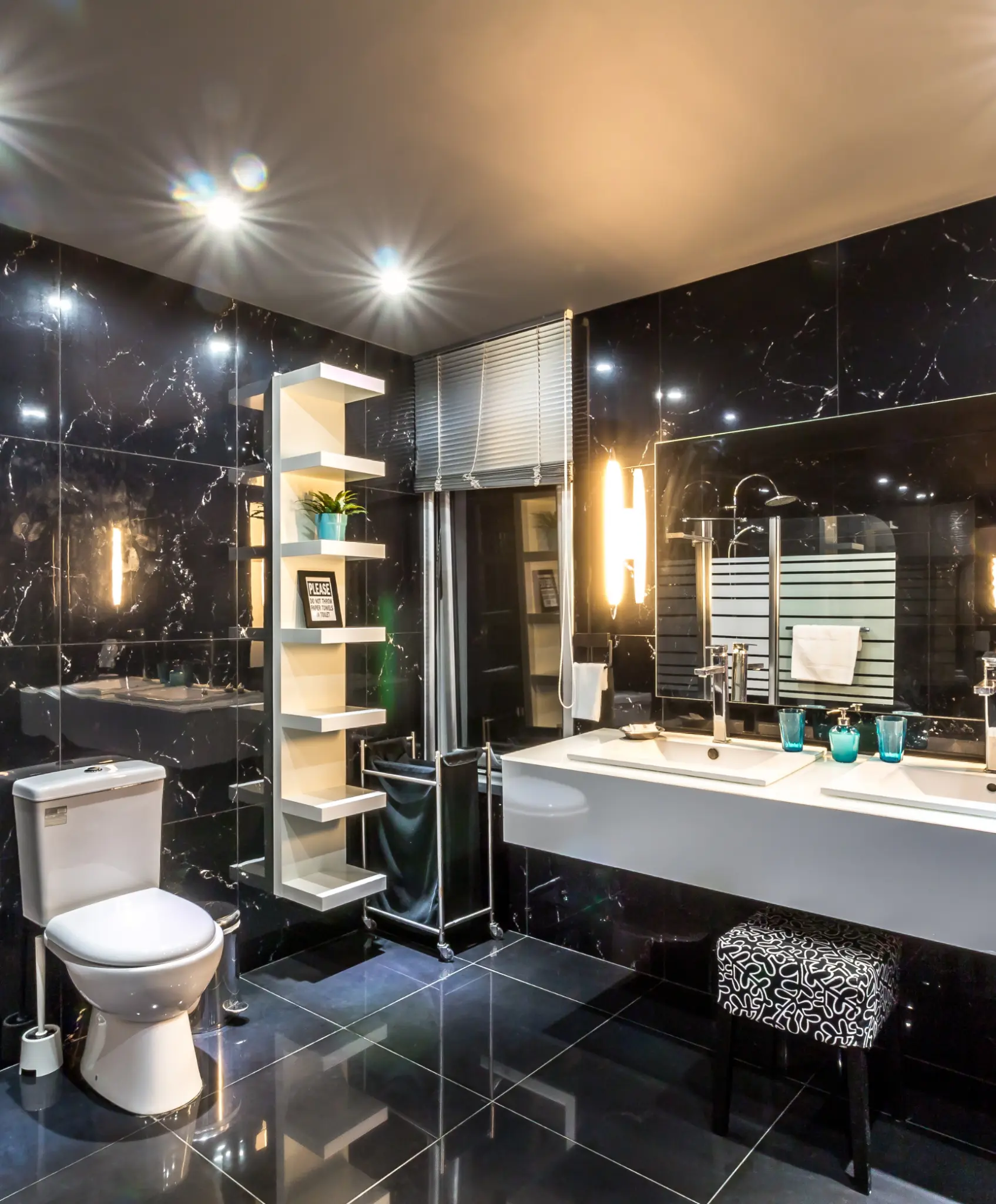 Luxurious bathroom with sleek black tile walls and ambient lighting