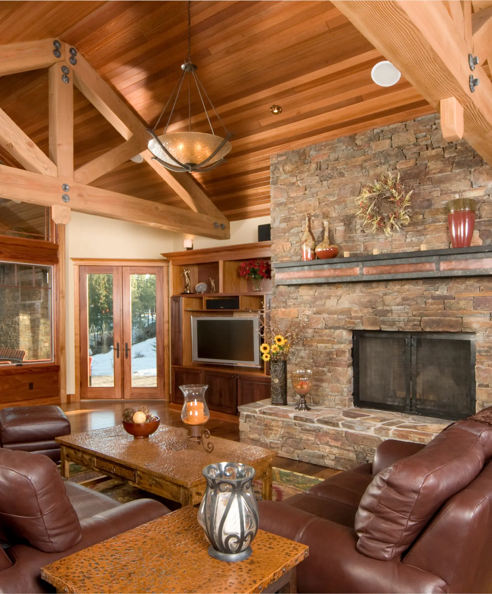 A contemporary living room featuring a sleek black-tiled fireplace with soft ambient lighting.