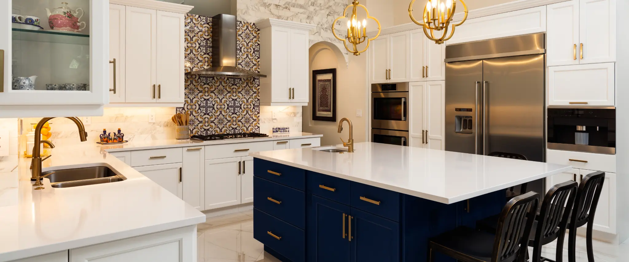 Luxury kitchen remodel with a navy blue island and golden fixtures