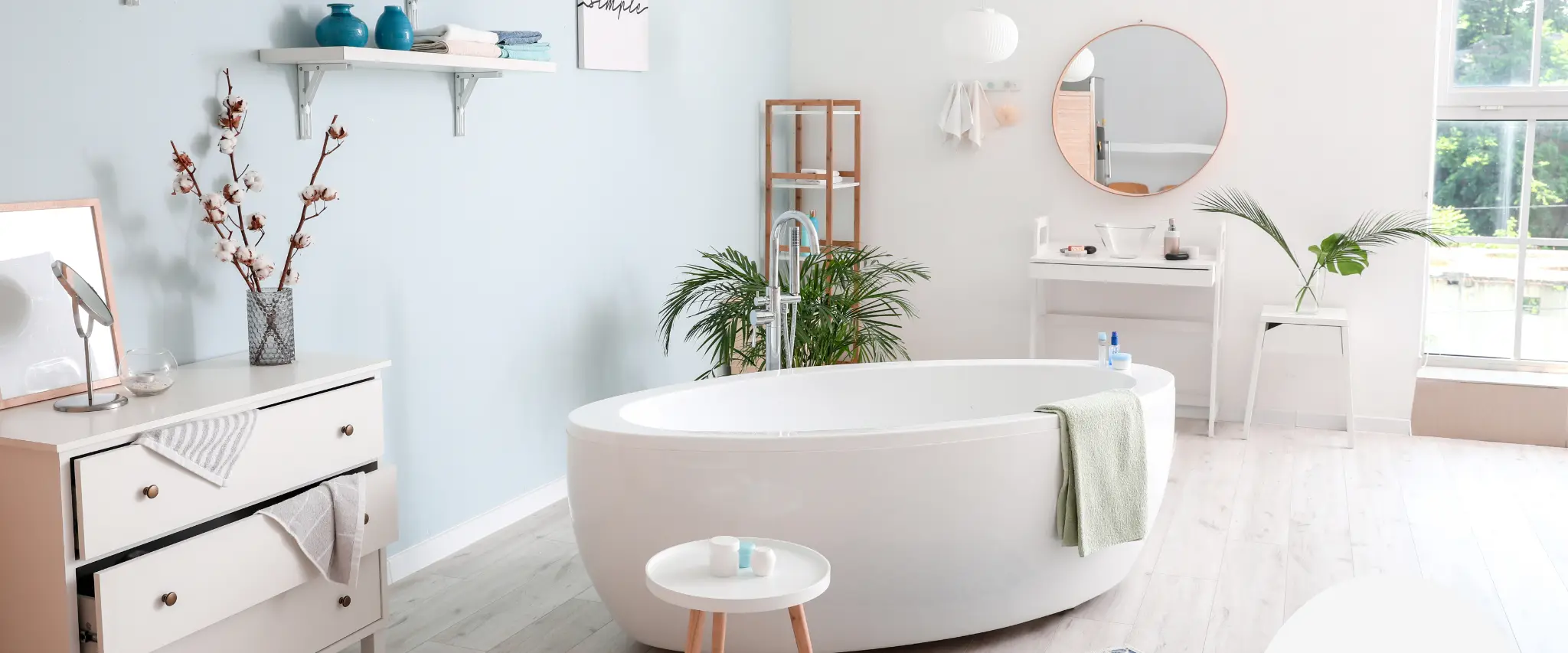 Minimalist modern bathroom with a freestanding bathtub and glass shower enclosure