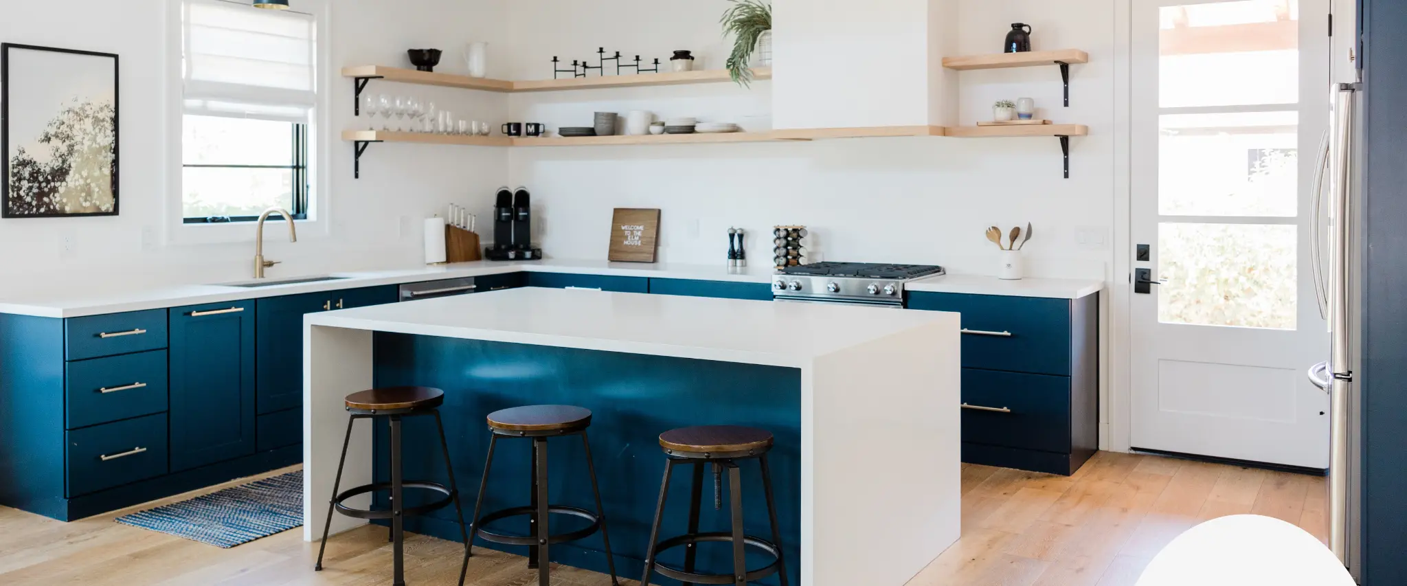 Modern kitchen with blue cabinets and white countertops