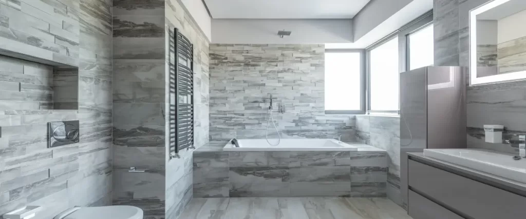 Modern bathroom with a large built-in bathtub and gray marble walls